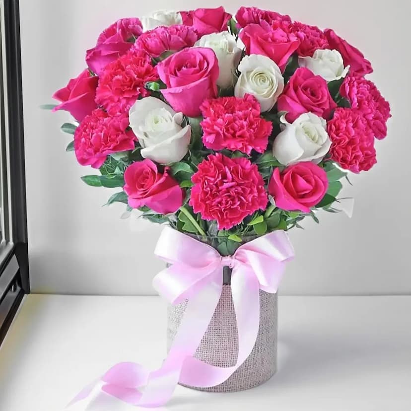 10 pink carnations, 6 white roses and 6 pink roses in a vase