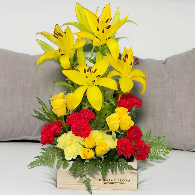 12 red carnations, 8 yellow carnations, 9 yellow roses, and 4 lilies in a wooden box