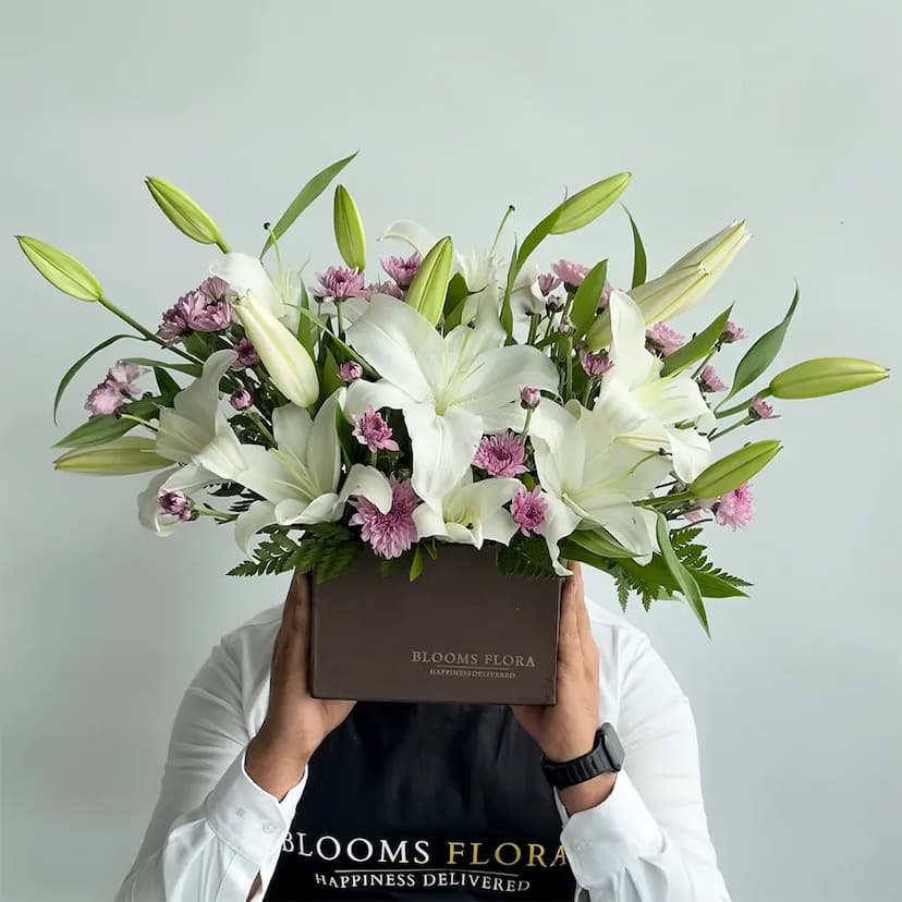 4 white lilies and 4 purple chrysanthemums in a square box