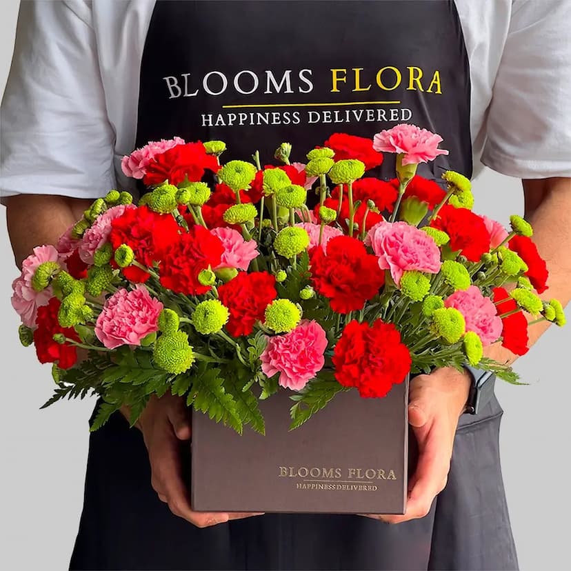 30 red and pink carnations with green chrysanthemums in a square box