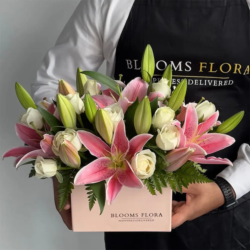 12 white roses and 3 pink lilies in pink box