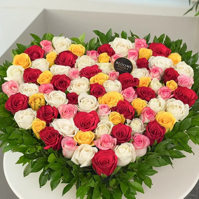 Heart shaped pink,yellow,white and red roses arrangement