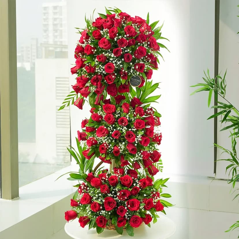 stand arrangment of 100 red roses