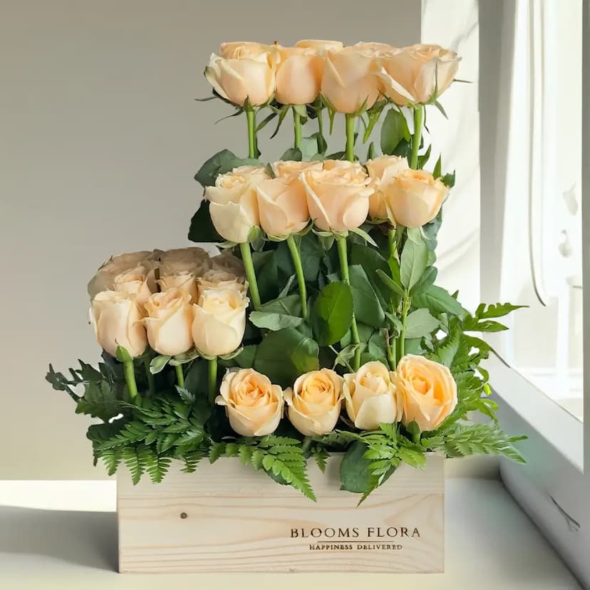 32 peach roses in a wooden box