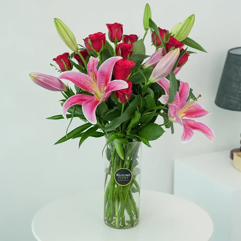 12 red roses and 3 pink lilies in a vase