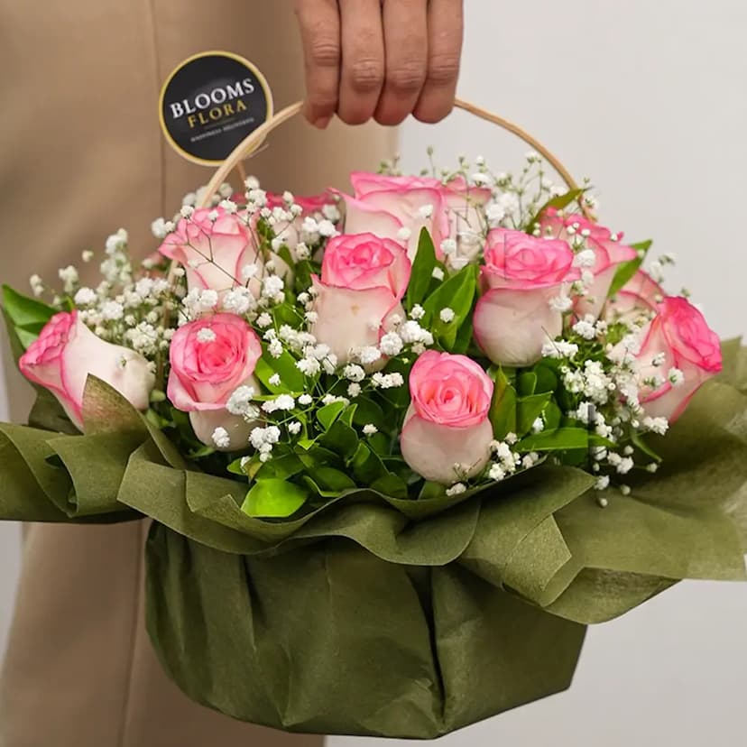 12 pink roses in a basket