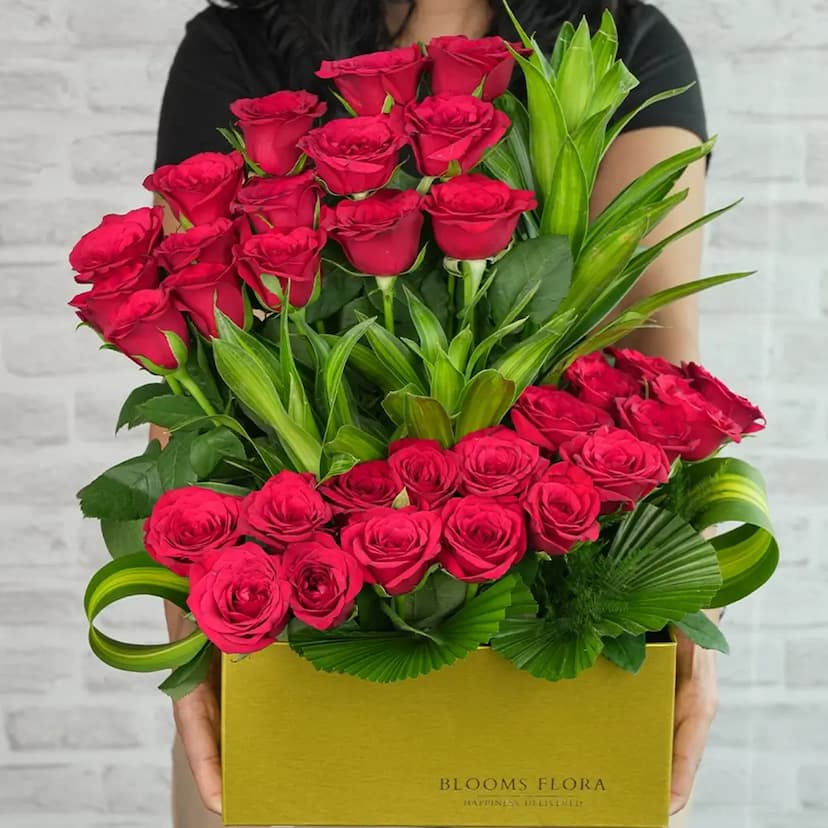 35 red roses in a gold box