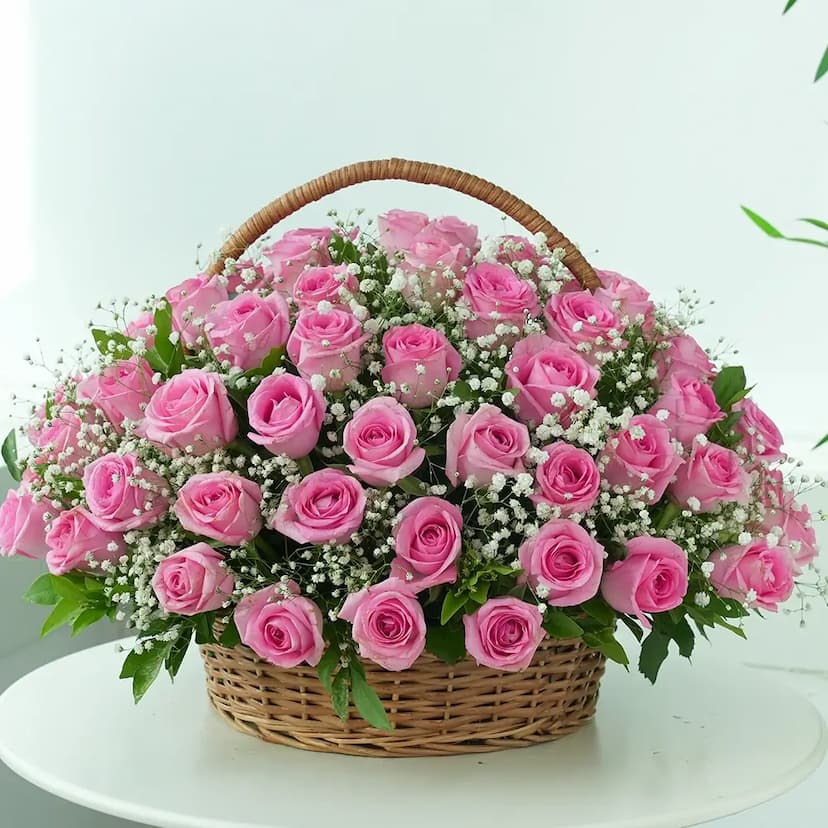 70 pink roses in a handle basket