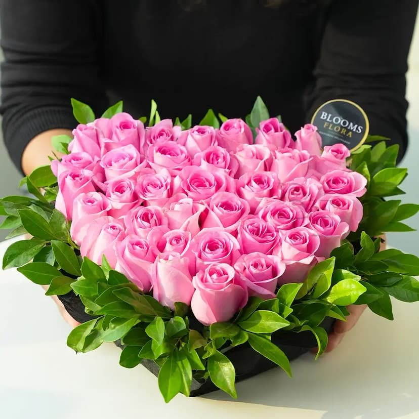 40 pink roses and kamini leaves arranged in heart shaped