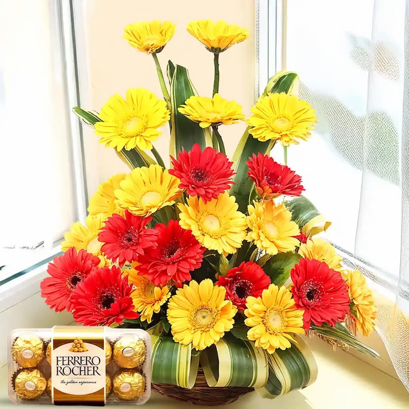 Red and yellow gerberas basket with chocolates