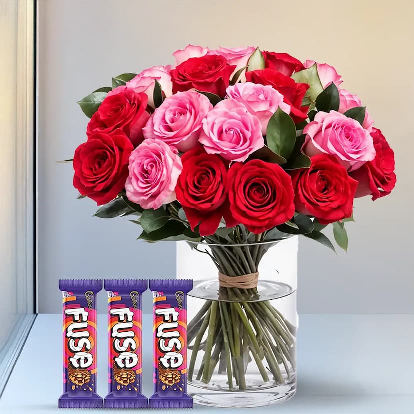 Red and Pink roses in vase with chocolates